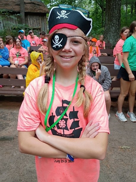 youth at camp donning a pirate hat and eye patch.
